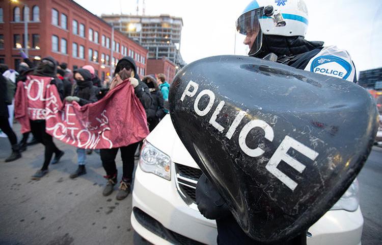 Police are seen at a demonstration of supporters of the indigenous Wet'suwet'en Nation in Montreal, Canada, on February 25, 2020. Canadian police recently arrested U.S. documentary filmmaker Melissa Cox. (Reuters/Christinne Muschi)